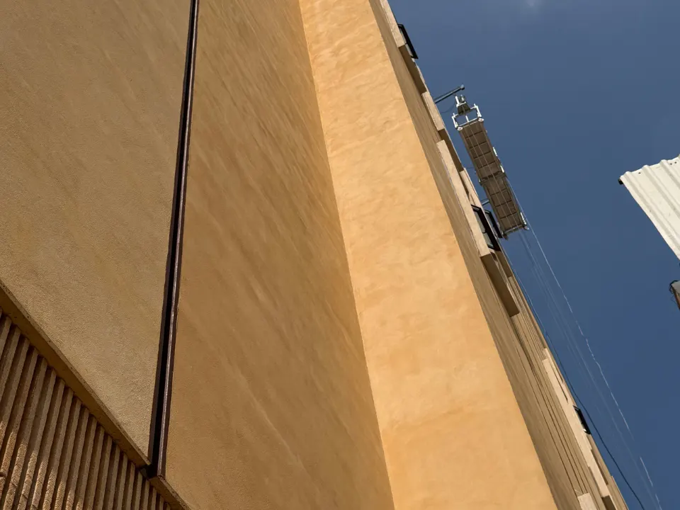 Fachada terminada con recubrimiento de gran formato en tono arena